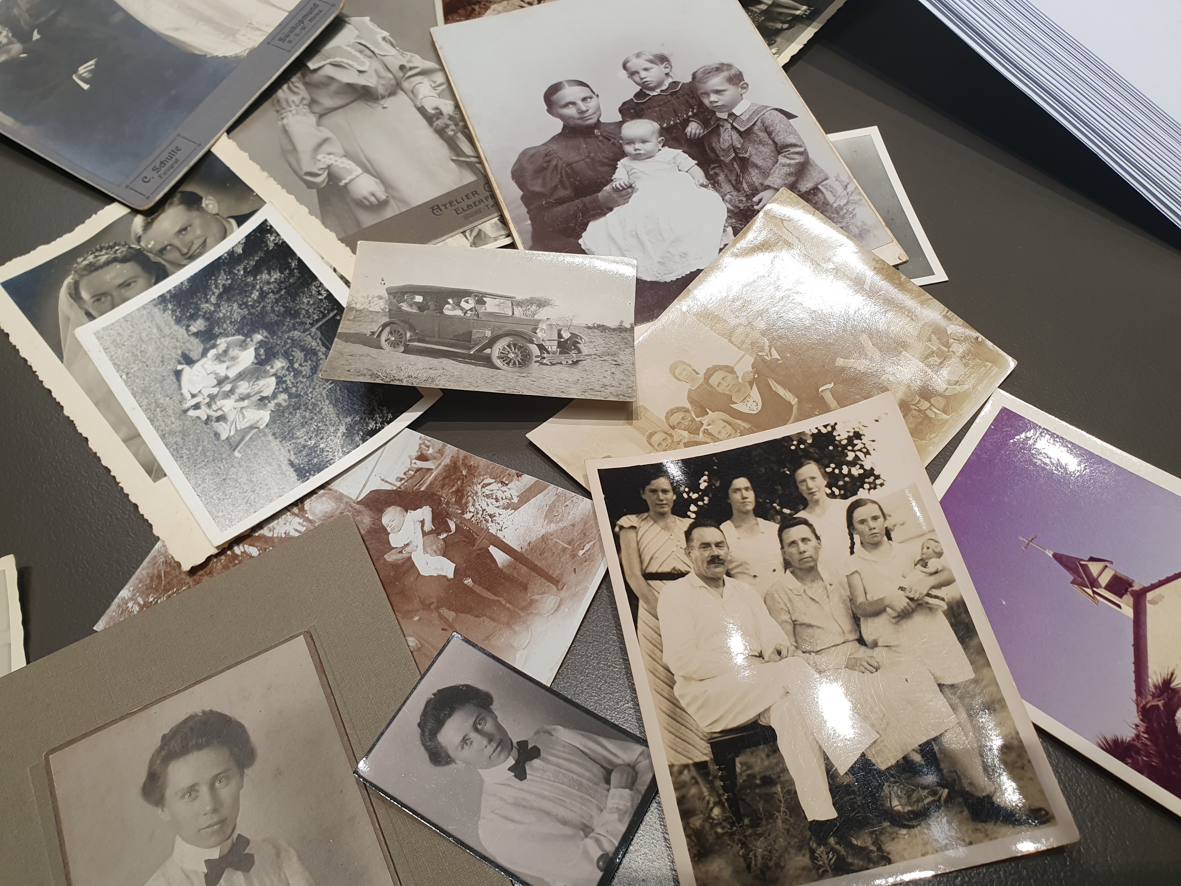 collection of old family photos scattered on a table