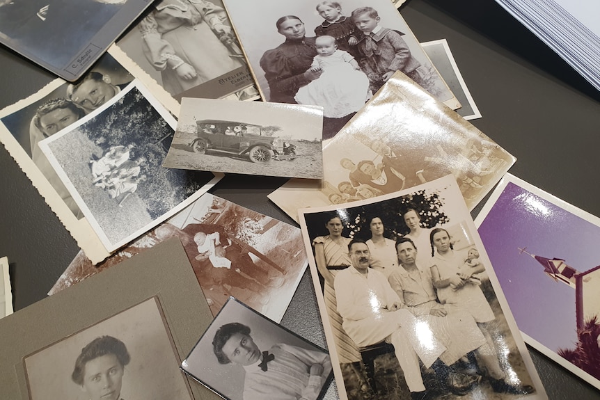 collection of old family photos scattered on a table