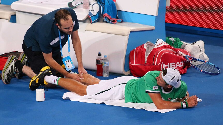 Australia's Matt Ebden receives treatment for a calf injury in the Hopman Cup match against Poland.