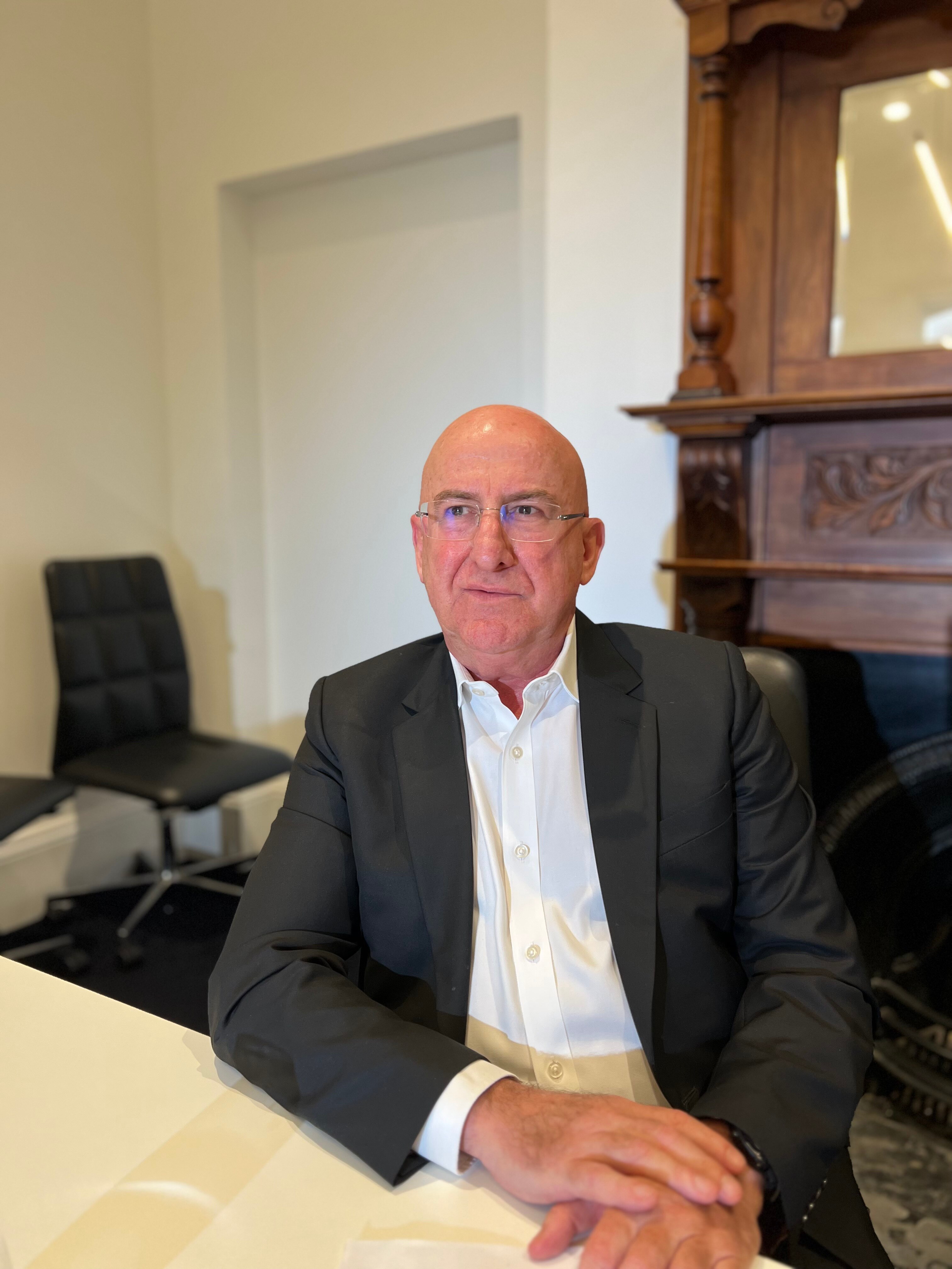 Rauf Soulio sits in a room looking off into the distance