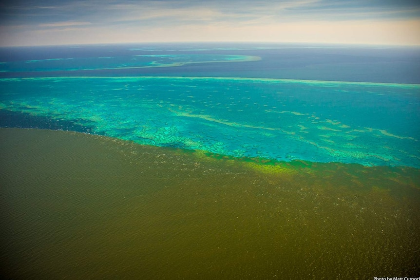 Aerial photo of plume from Burdekin River inundating Old Reef, Stanley and Darley beyond on central Great Barrier Reef.