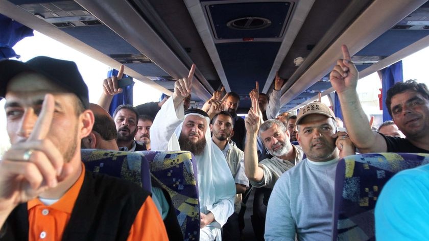 Pro-Palestinian activists sit on a bus after they were deported