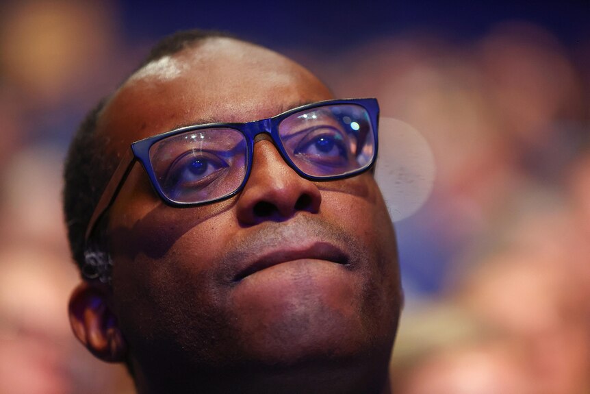 kwasi kwarteng close up as he watches attentively from the audience at the conservative party conference