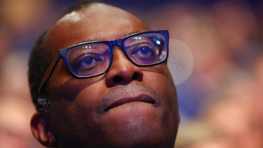 kwasi kwarteng close up as he watches attentively from the audience at the conservative party conference
