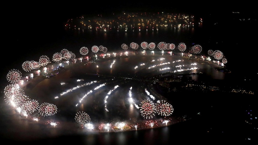 Fireworks explode over Palm Jumeirah in Dubai to celebrate the new year.