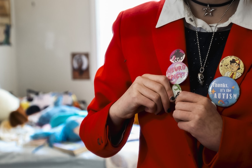 Clare's blazer buttons read 'Thanks for the autism' and 'Neurospicy'