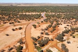 An aerial photograph of a flooded outback road