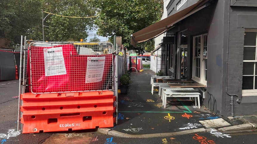 Construction opposite a cafe.