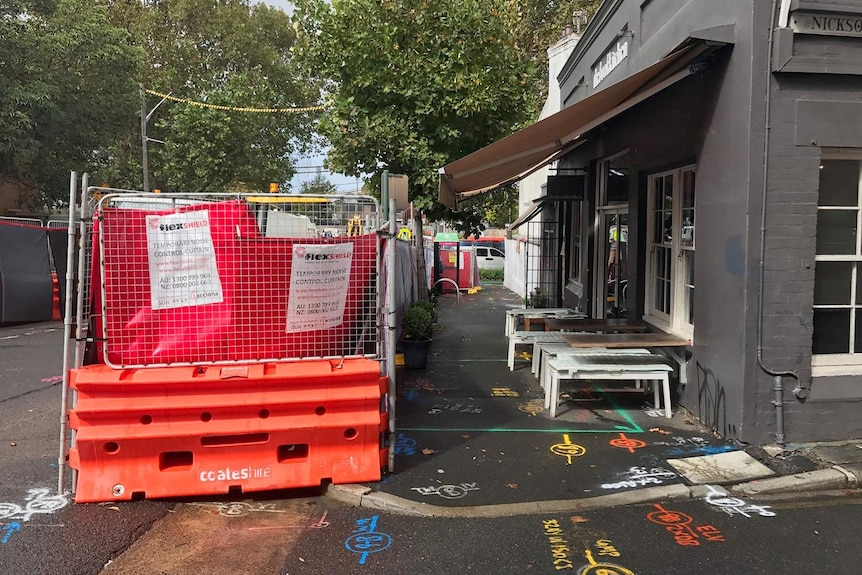 Construction opposite a cafe.