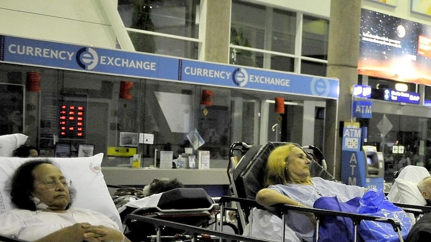 Hospital patients wait in the international terminal building at Cairns Airport.