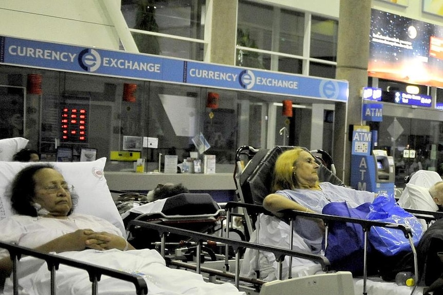 Hospital patients wait in the international terminal building at Cairns Airport