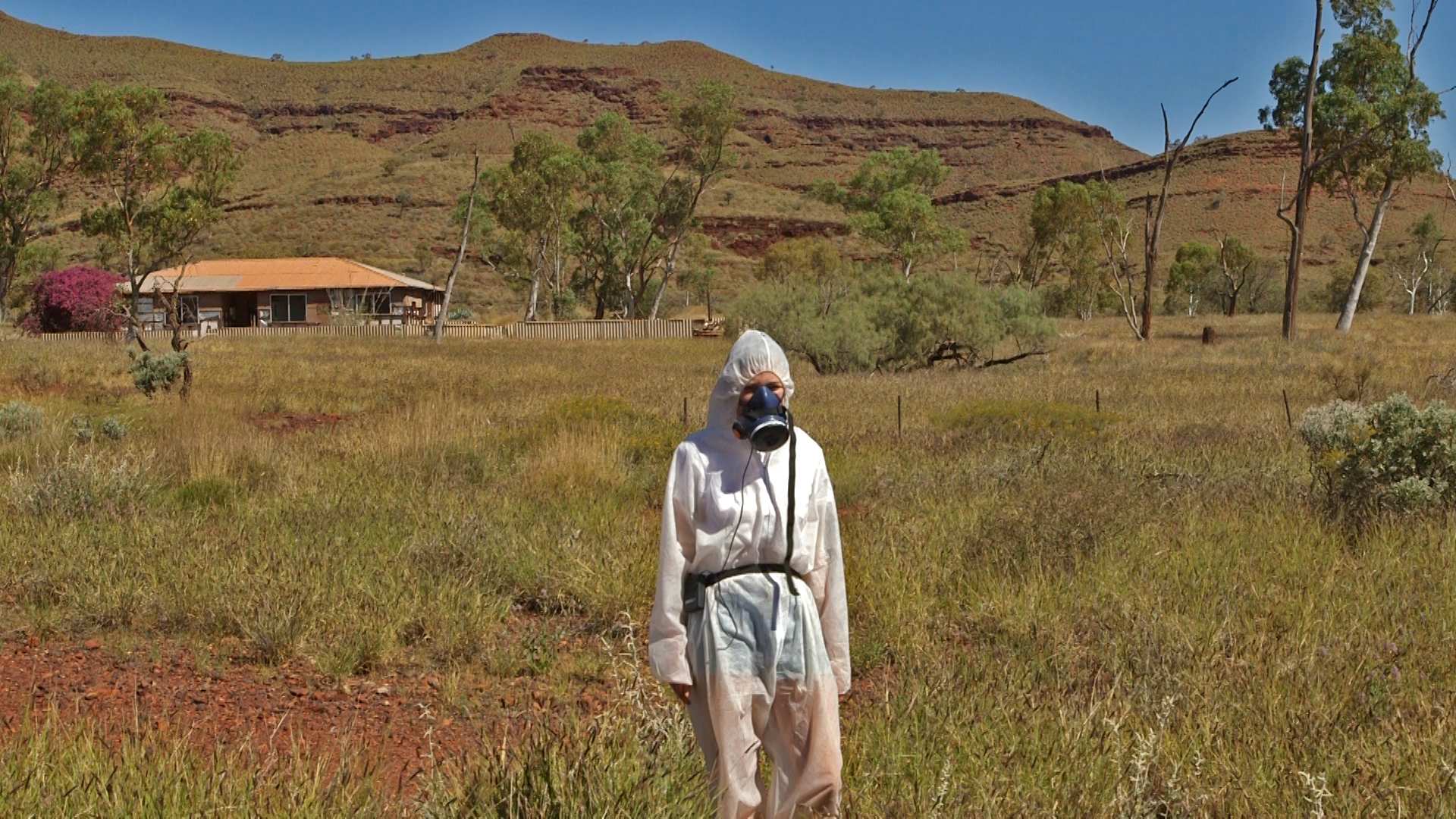 Reporter Melanie Garrick wears a respirator and protective clothing in Wintenoom.