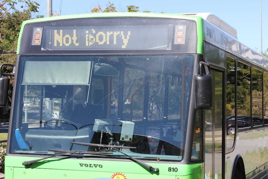 A bus shows the words "Not sorry" on its LED display.
