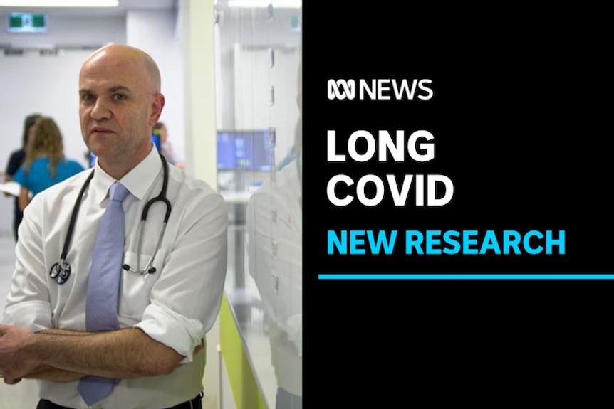 Long Covid, New Research: A man with a stethoscope around his neck stands in a hospital corridor.