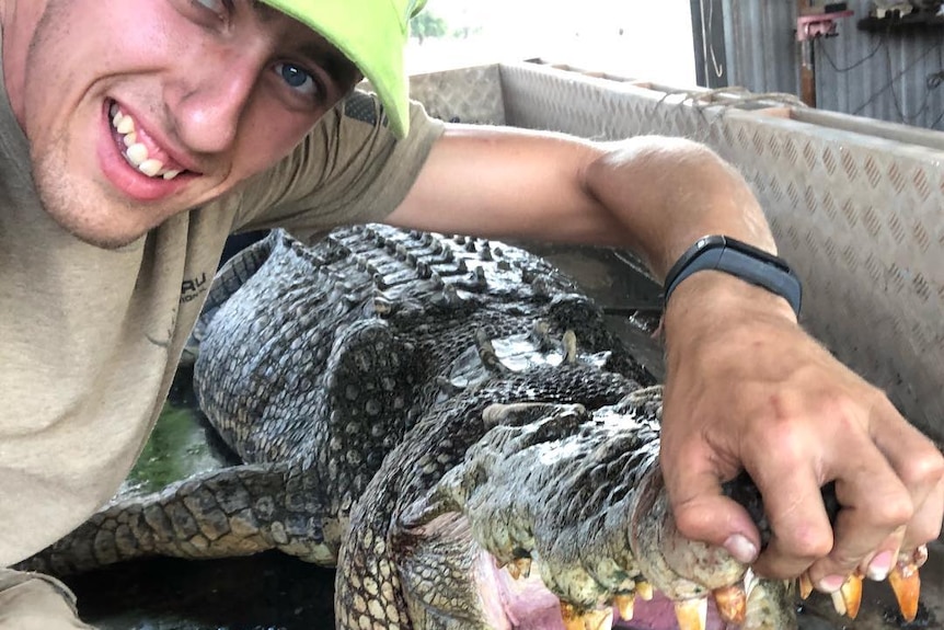 Danish hunter Niels Jensen poses with a crocodile.