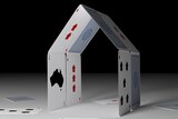 Playing cards in the shape of a house.