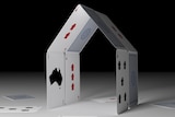 Playing cards in the shape of a house.