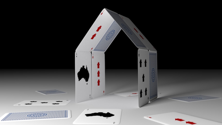 Playing cards in the shape of a house.