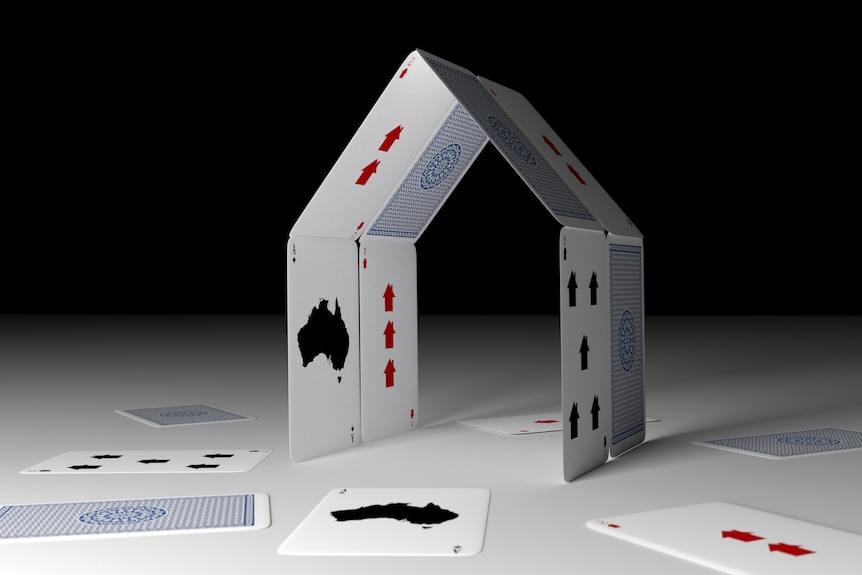 Playing cards in the shape of a house.