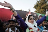 Former Pakistani prime minister Benazir Bhutto waves to her supporters