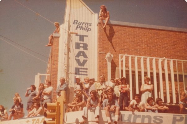 Crowd sitting on buildings during festival