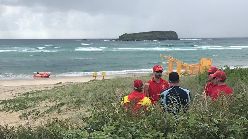 Surf Rescue Duty Officer Chris Samuels discusses progress of operation to recover body of a man at Fingal Beach.