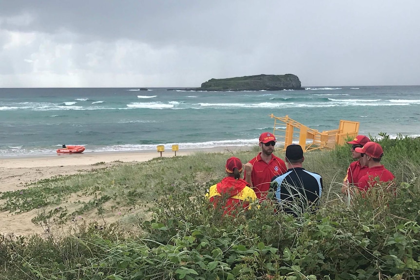 Surf Rescue Duty Officer Chris Samuels discusses progress of operation to recover body of a man at Fingal Beach.