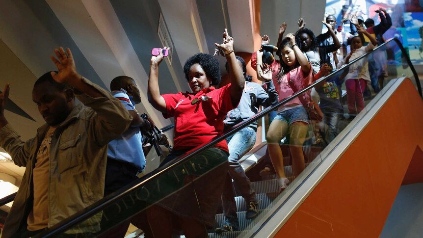 Civilians evacuate an area at the Westgate Shopping Centre amid an attack by Al Shabaab gunman on September 21, 2013.