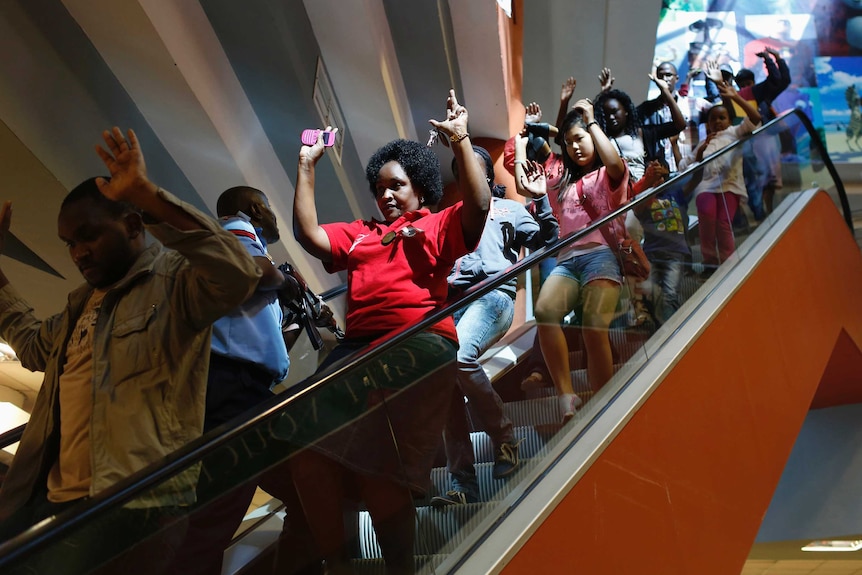 Civilians evacuate an area at the Westgate Shopping Centre amid an attack by Al Shabaab gunman on September 21, 2013.