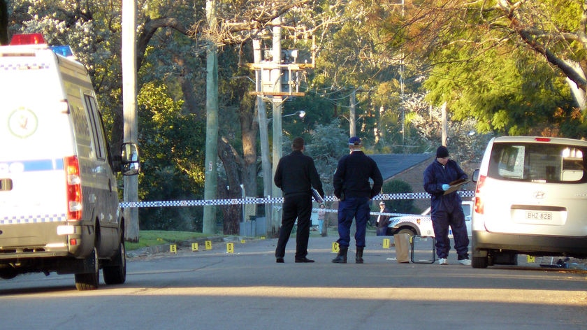 Police inspect the area for evidence after the fatal shooting in Raymond Terrace on June 30, 2010.