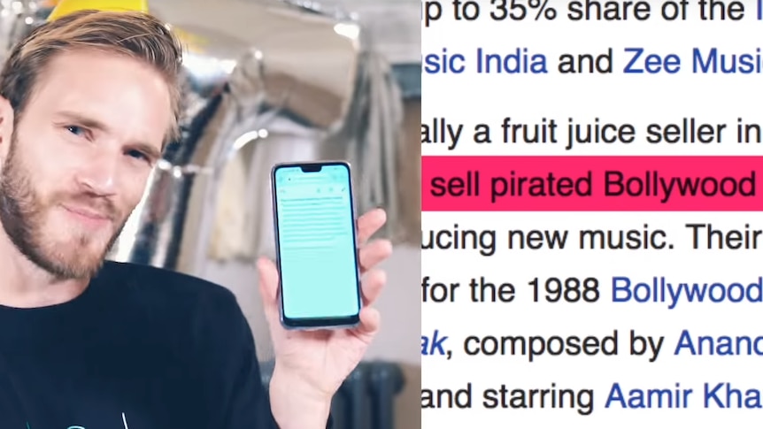 PewDiePie holds up his phone to show the Wikipedia page