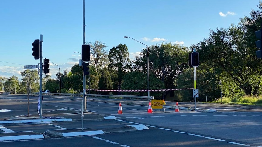 Road blocked with 'road flooded' sign at intersection