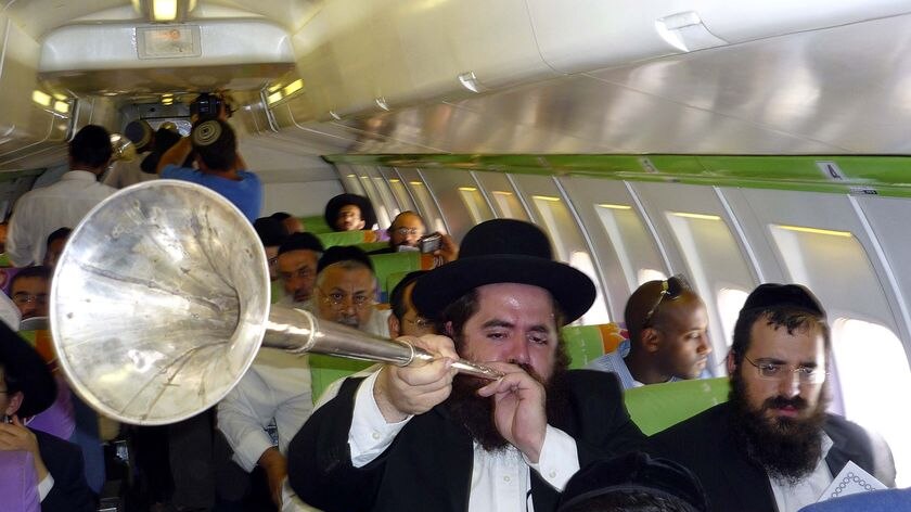 The rabbis chanted prayers and blew ceremonial trumpets as their plane circled.