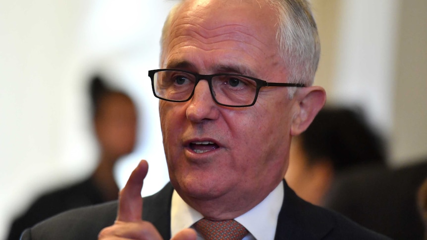 Malcolm Turnbull raises a fingers as though he is making an interesting point