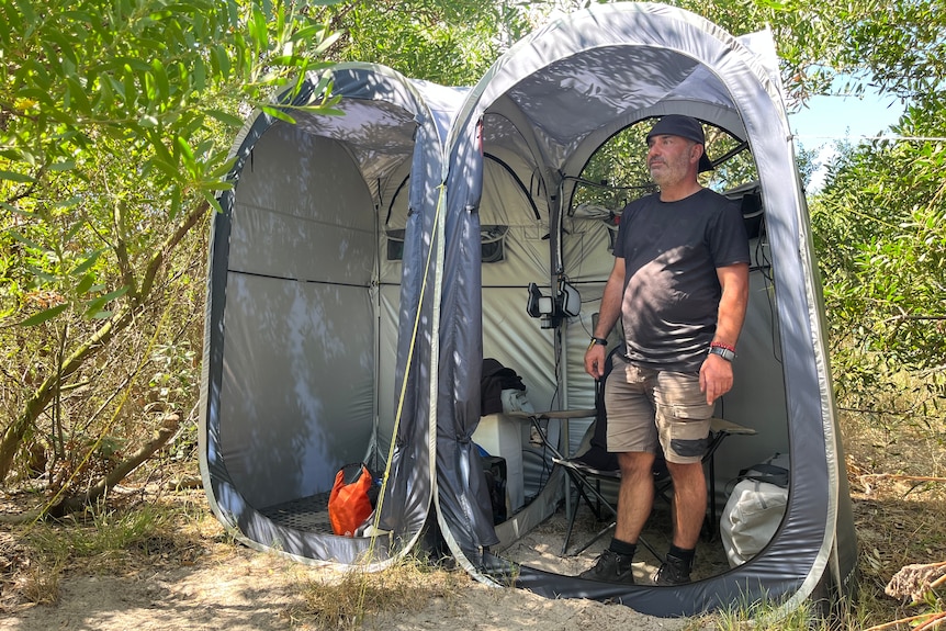 Man stands in a tent.