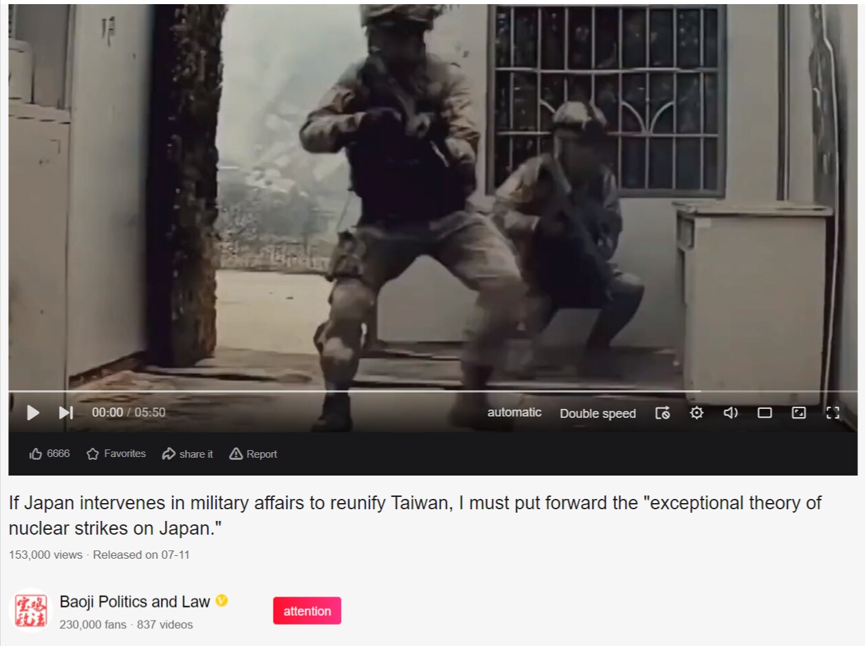 A screen shot of the video shows armed figures in combat attire. 