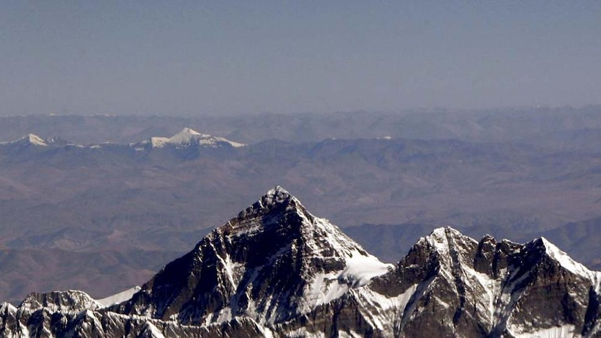 Mount Everest rises above the other peaks around it