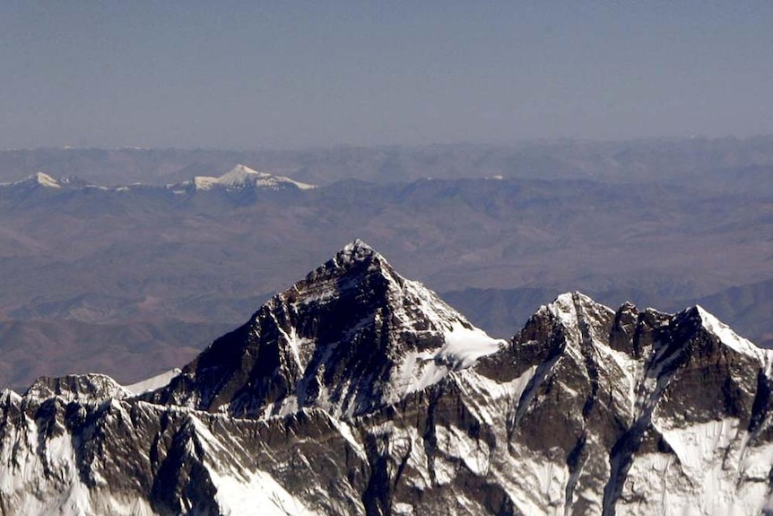Mount Everest rises above the other peaks around it
