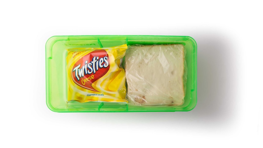 A Nutella sandwich and a packet of Twisties in a clear green lunch box.