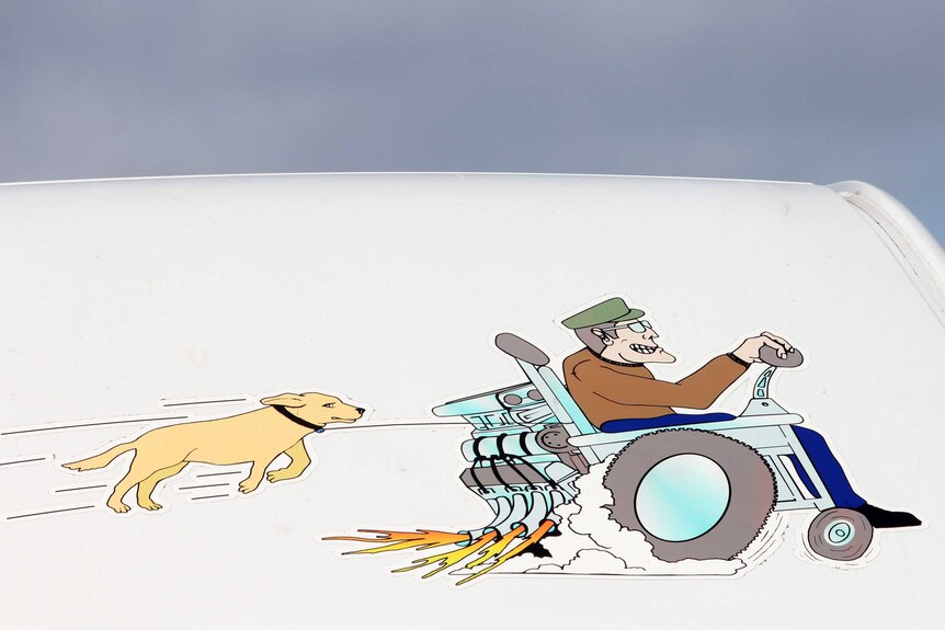 A drawing of a man in a wheelchair with a dog following