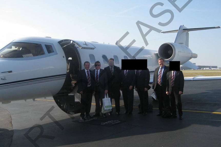 Former Ipswich mayor Paul Pisasale, Councillor Paul Tully, and Carl Wulff with private plane in the background