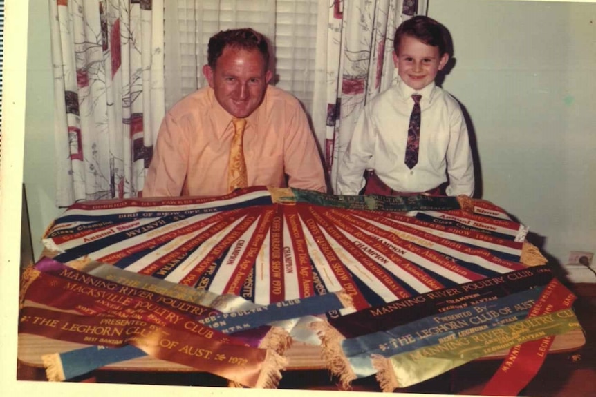 Lachie as a young boy with his father Peter and their winning ribbons.