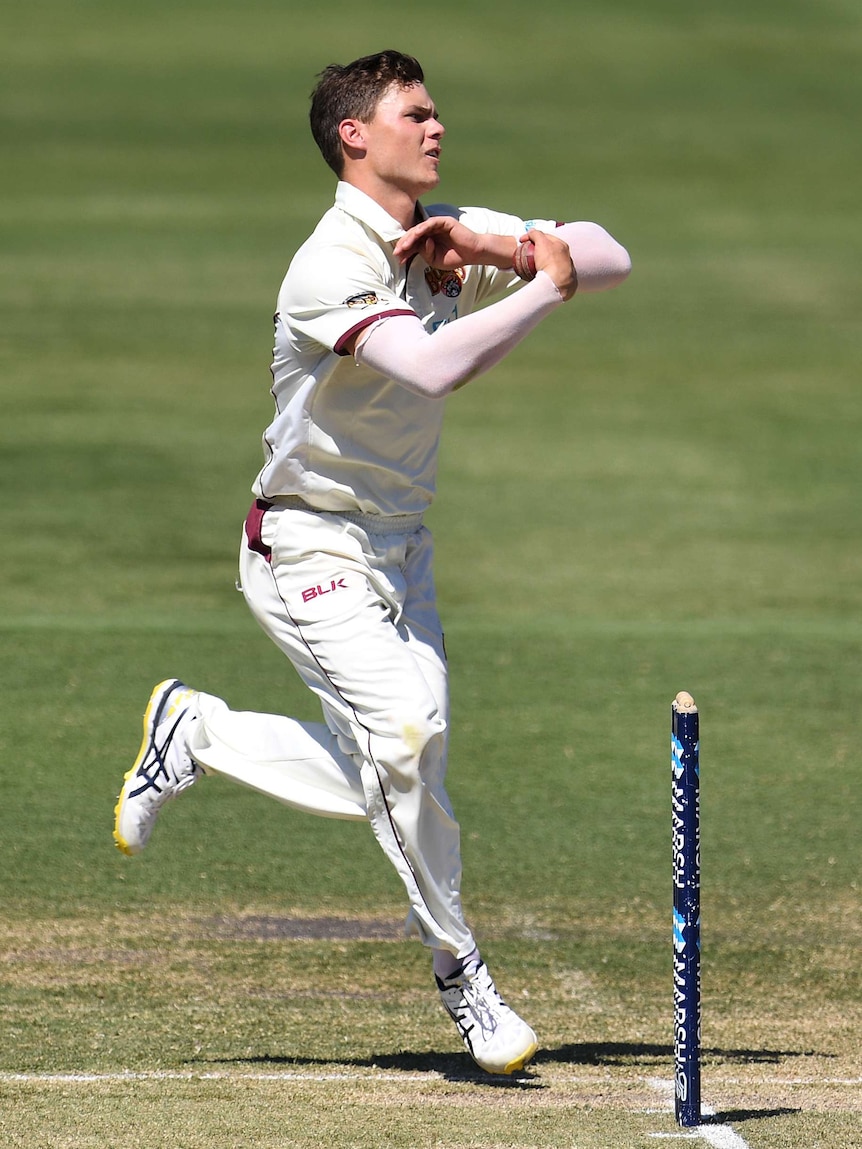 A leg spinner from Queensland runs in to bowl against New South Wales in a Sheffield Shield cricket match in Adelaide.