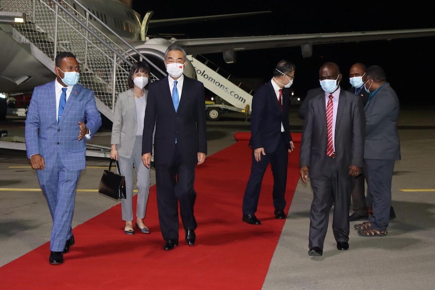 Solomon Islands Foreign Minister Jeremiah Manele welcomes his Chinese counterpart Wang Yi at the airport