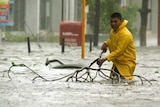 Hurricane Wilma: a man wades through a flooded street at the resort town of Cancun.