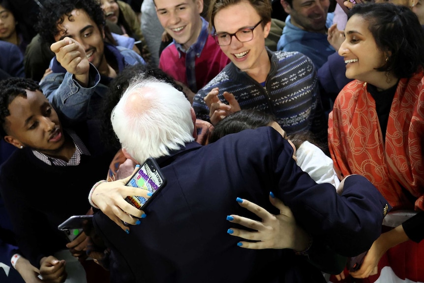 Bernie Sanders getting a hug from a supporter