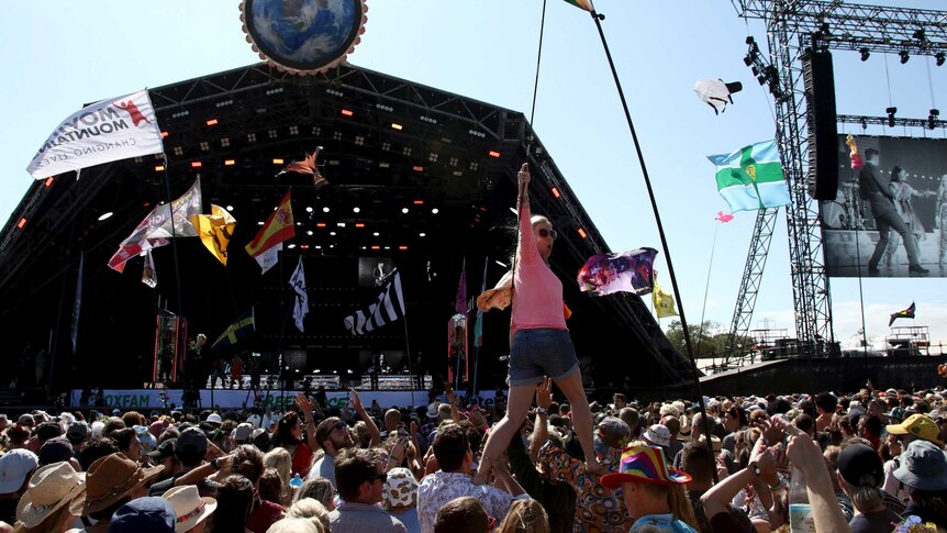Revellers react to Kylie Minogue as she performs at the outdoor Glastonbury Festival.
