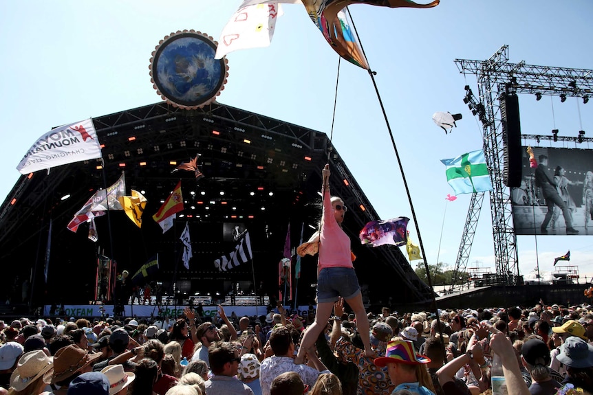 Revellers react to Kylie Minogue as she performs at the outdoor Glastonbury Festival.