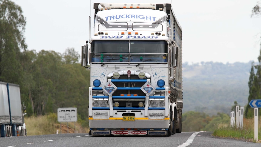 A large truck drives down a road