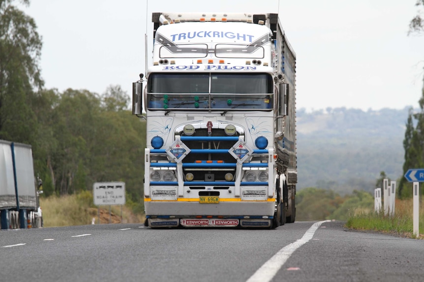 A large truck drives down a road